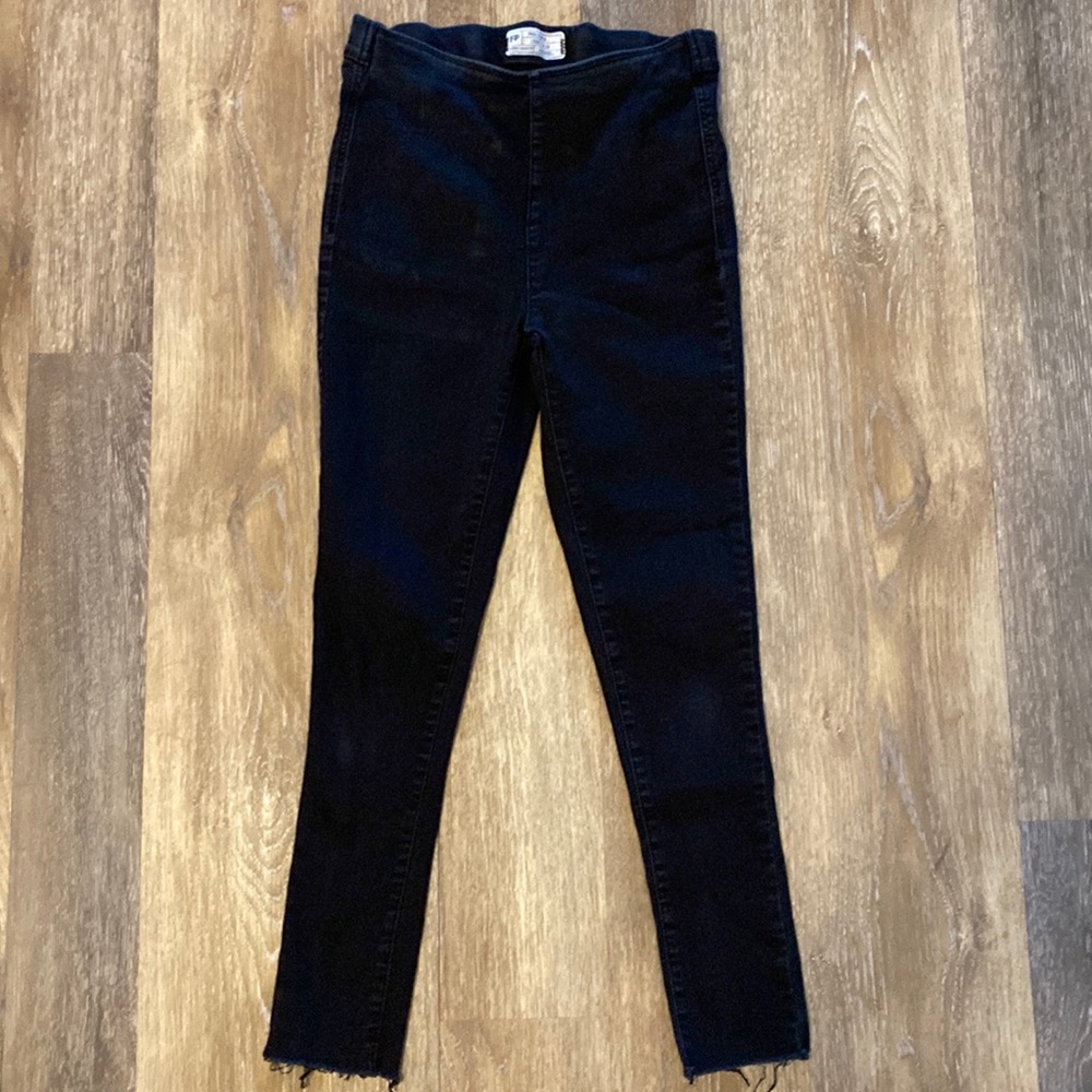 Free People black jeans with frayed ends.
